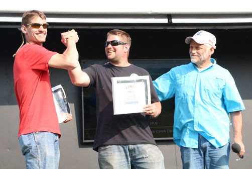 Brothers Jarvis (left) and Matt Kaderlik celebrate after emcee John Dainsberg announces them as winners of the 11th Leech Lake Walleye Tournament.